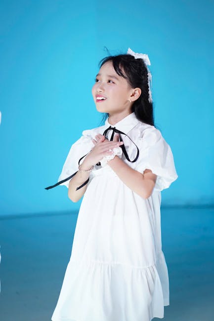 Happy girl performs a playful yoga pose on a brightly colored mat